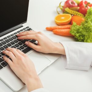 Female nutritionist working on laptop